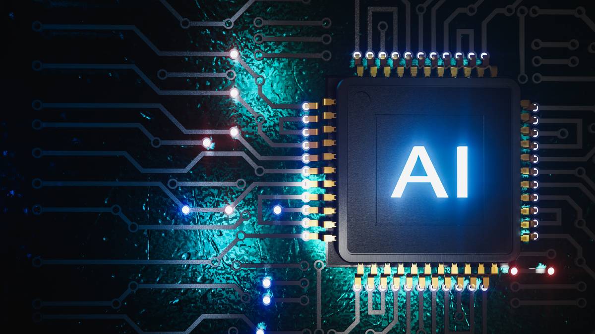 La imagen muestra un chip de computadora con la inscripción 'AI' iluminada, rodeado de circuitos electrónicos.